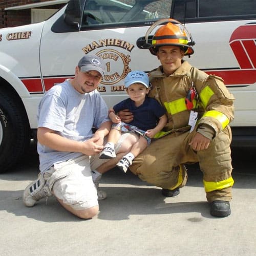 Tom and his son at the fire department