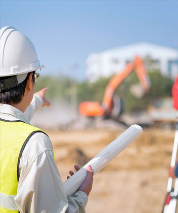 construction working pointing towards new building location