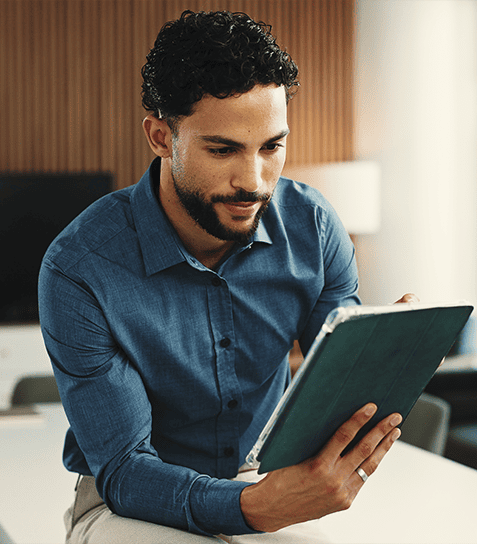 Typing on tablet man in office